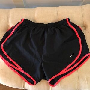 Black Dri-Fit Nike shorts with coral trim